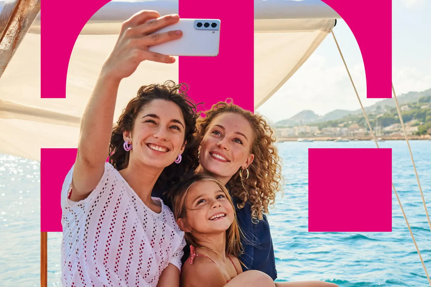 Young mothers with a child on a ship taking a selfie