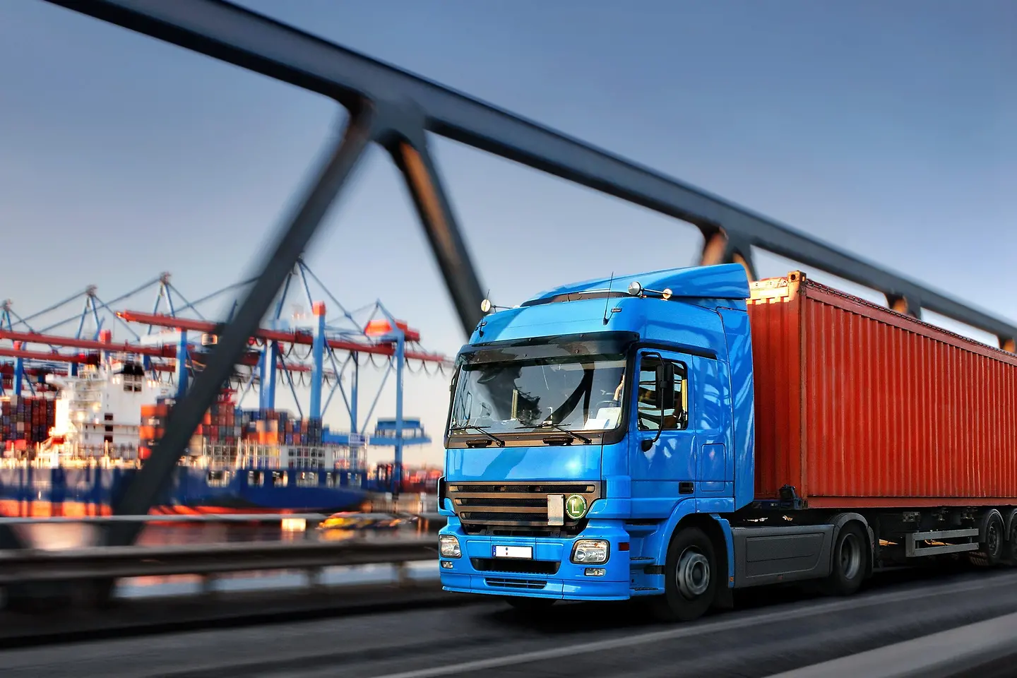 Camión sobre un puente con el puerto de fondo