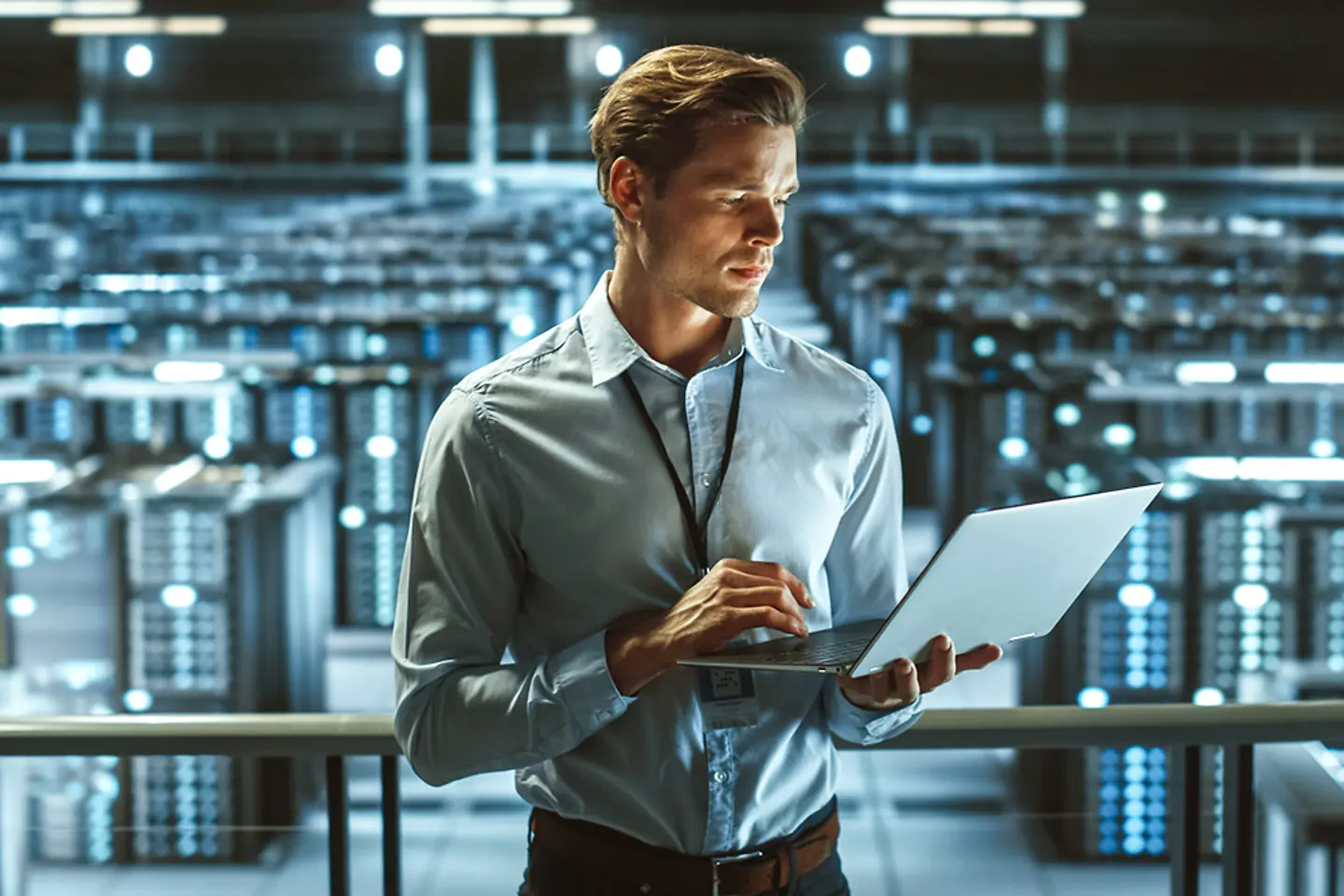 Portrait of IT Specialist Uses Laptop in Data Center.