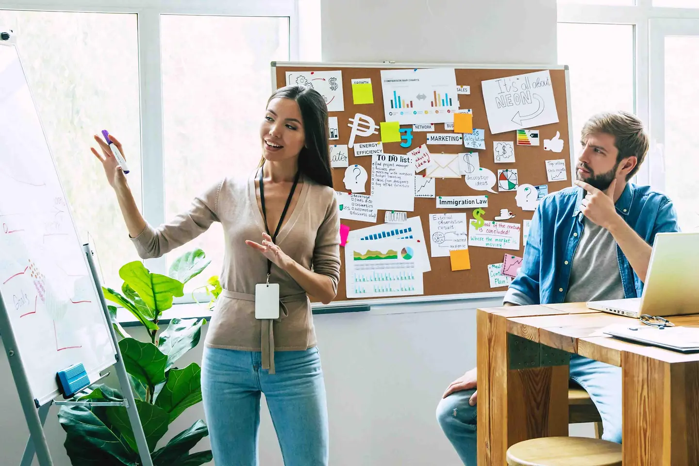 group of young employees discussing in front of a flip chart