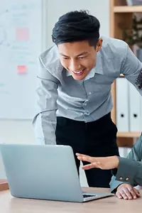 Business people in front of laptop are happy about cyber security success 