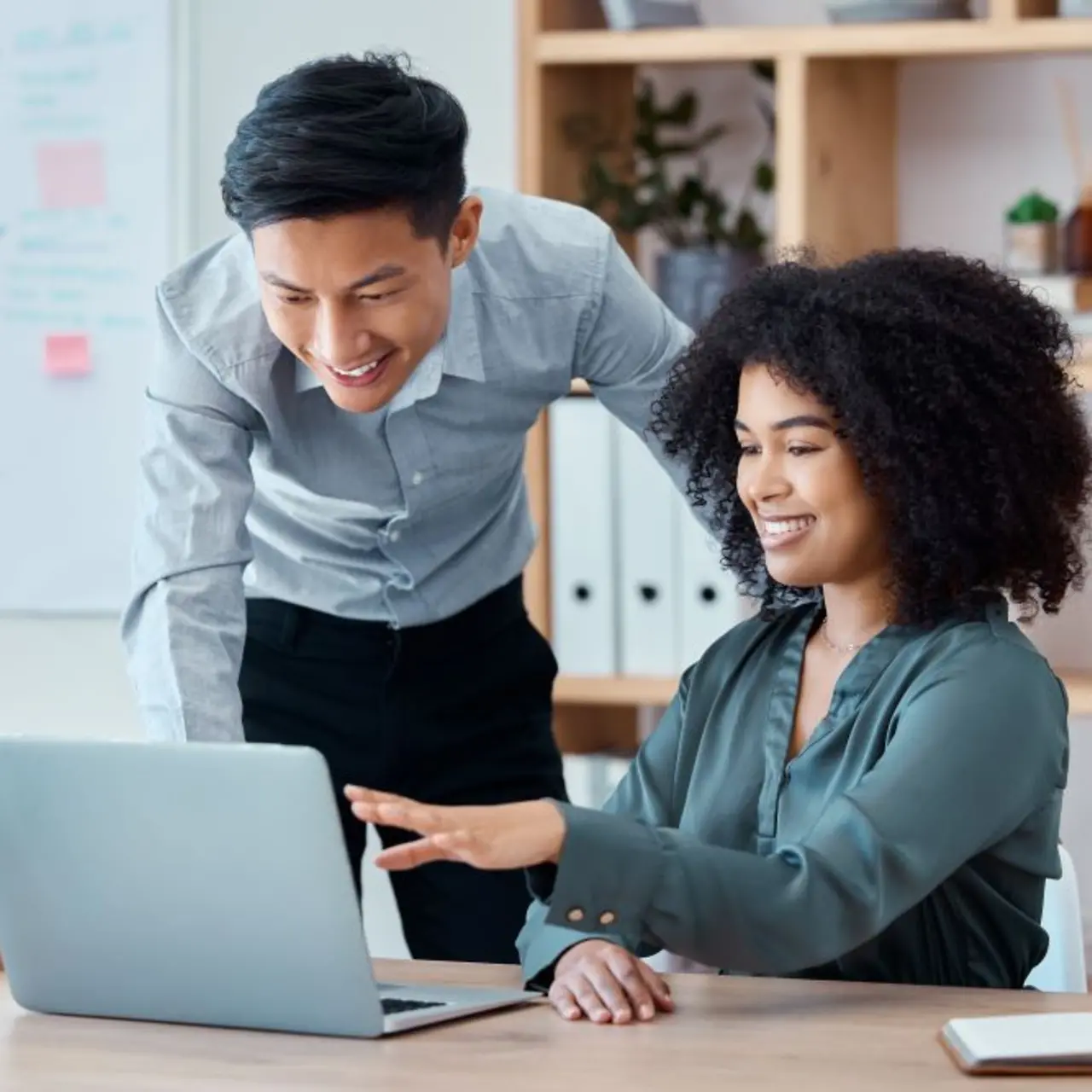 Business people in front of laptop are happy about cyber security success 