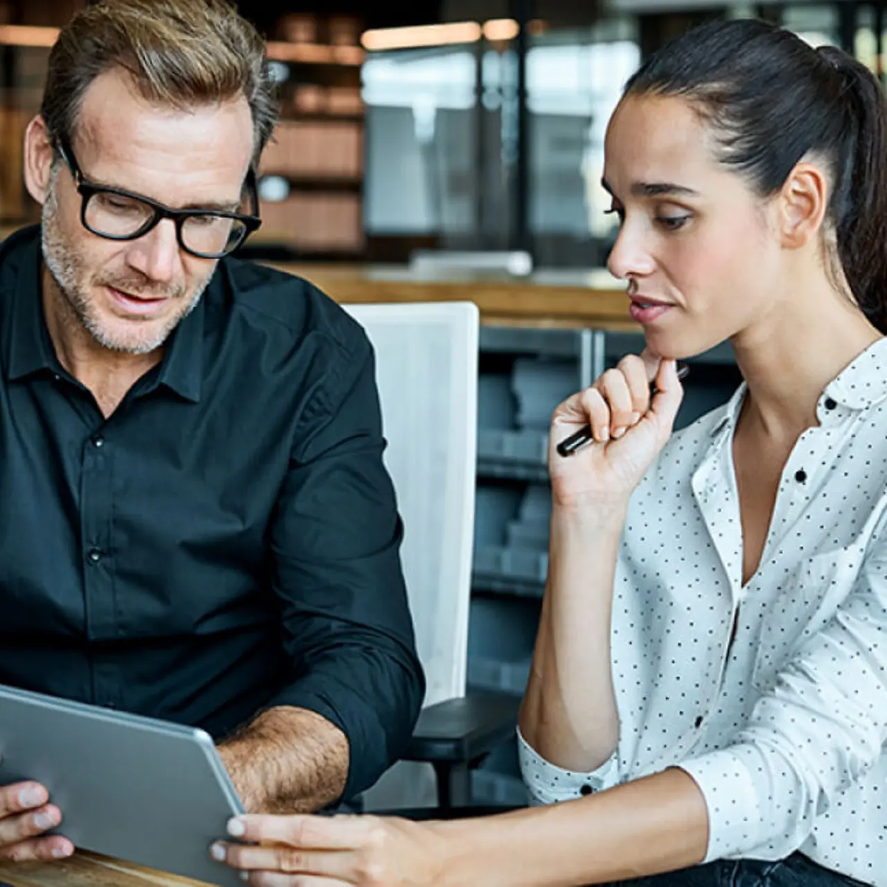colleagues looking at tablet PC