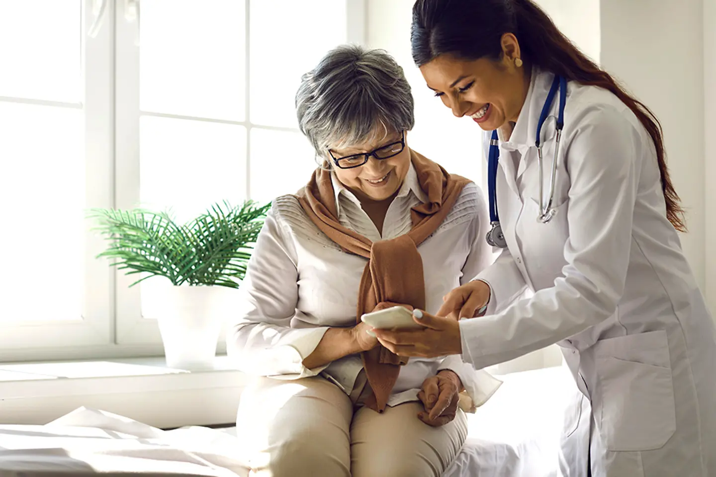 Doctor and patient using Epic Cloud-based Healthcare solution app on a mobile phone