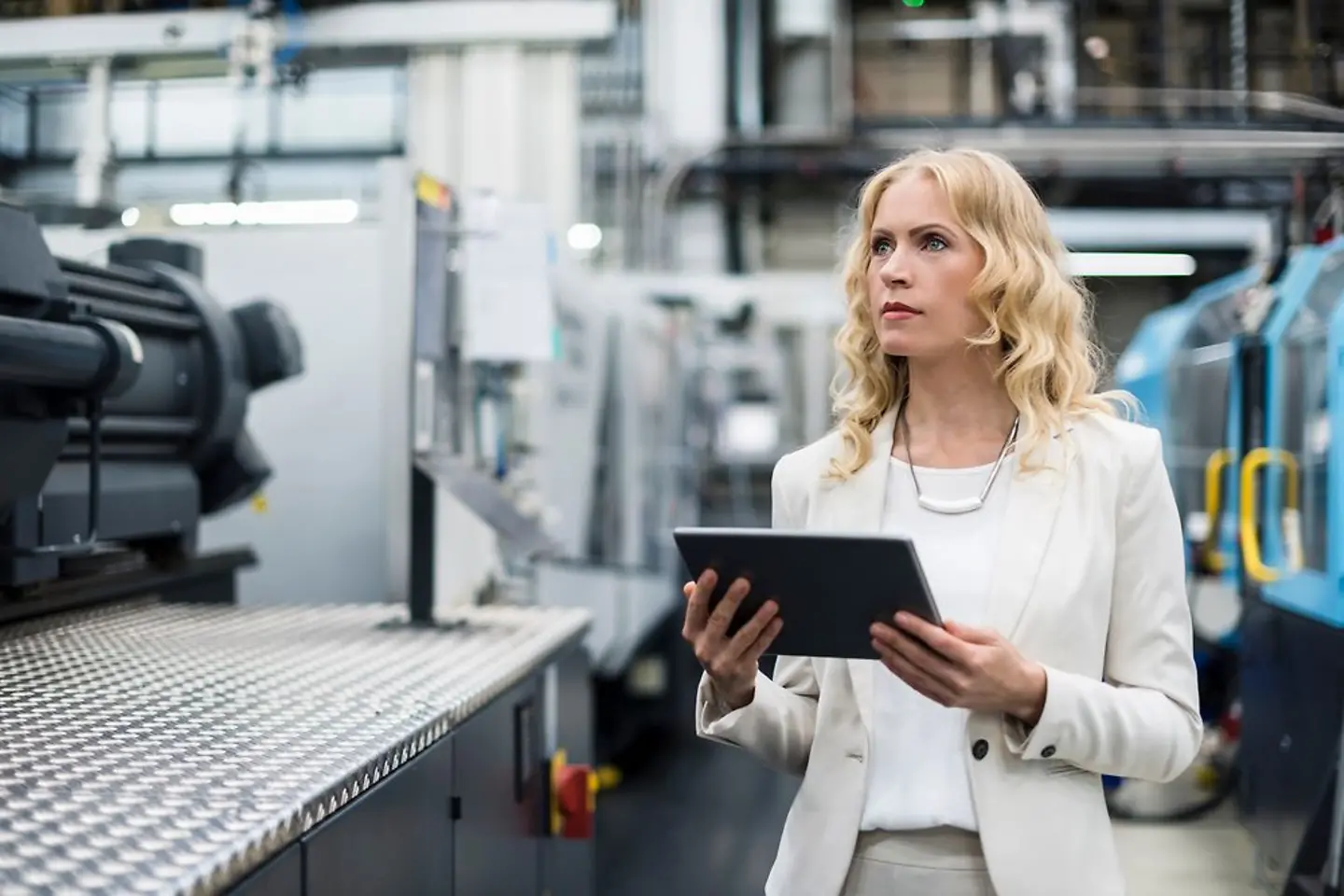 Female professional working on production systems in factory